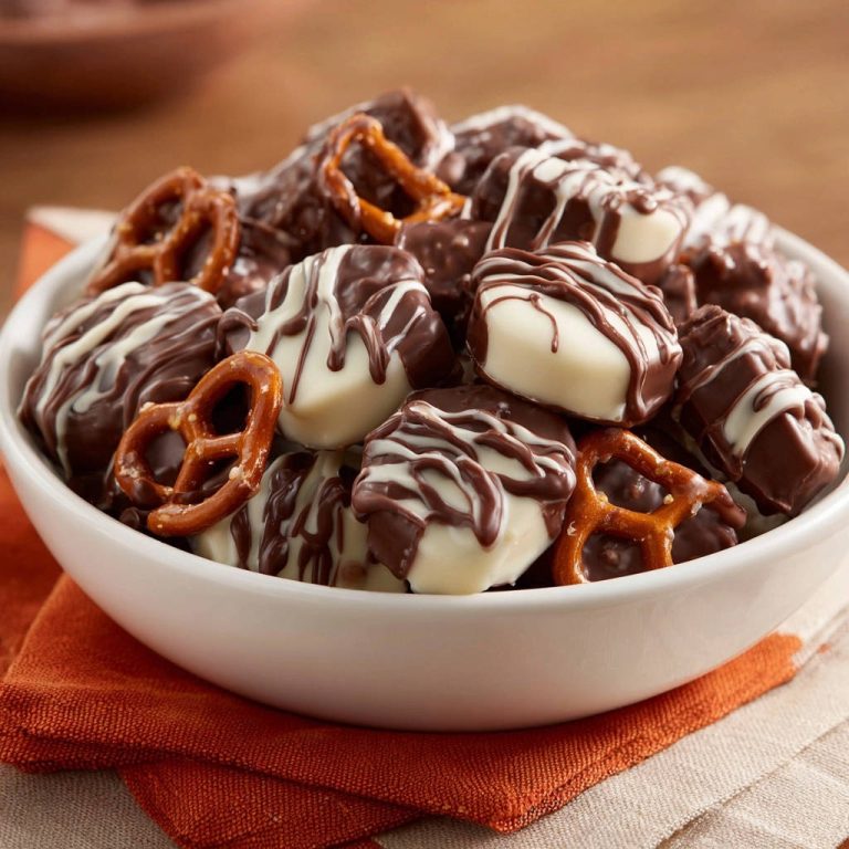 Edle Schoko-Brezel-Knabbereien in Nahaufnahme, drapiert in einer weißen Schüssel, mit perfekt glänzender Schokolade und knusprigen Brezeln.