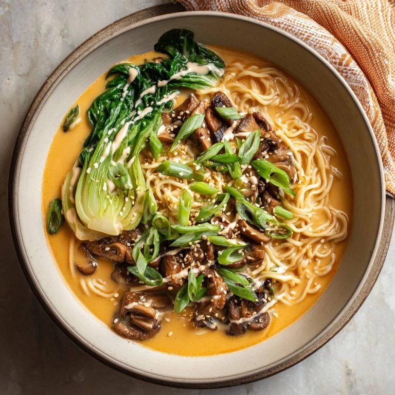 Cremige Shiitake-Bok-Choy-Ramen, serviert in einer Schüssel mit frischem Gemüse, Pilzen und Nudeln, aus der Vogelperspektive gesehen.