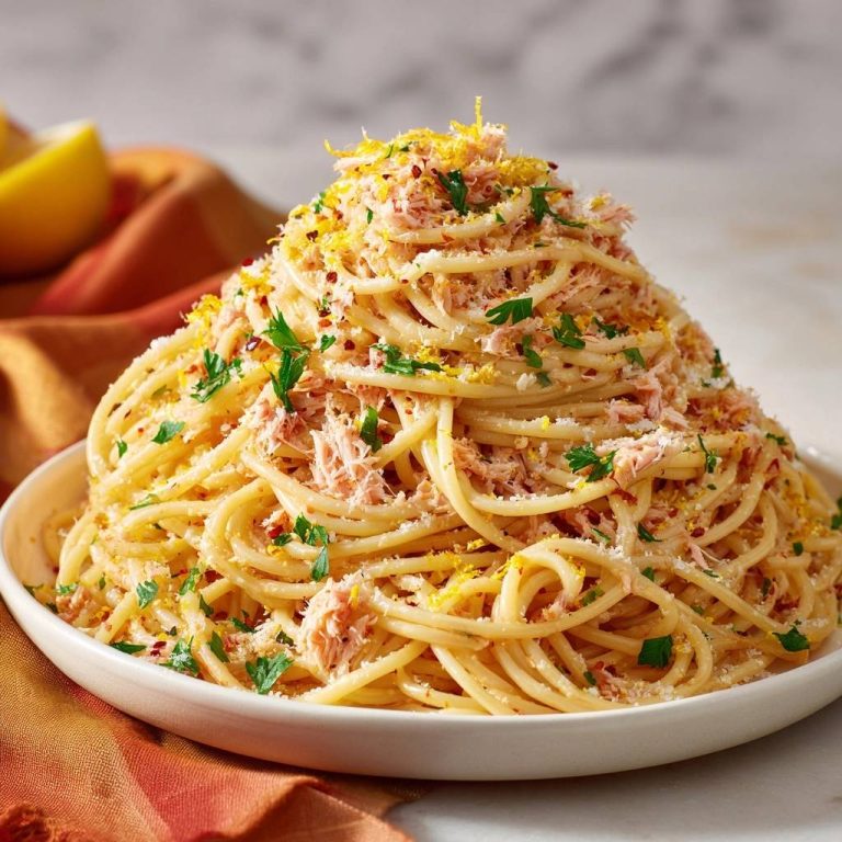 Zitronen-Thunfisch-Spaghetti in einer großen Schüssel, serviert und mit Zitronenschale und frischen Kräutern garniert.